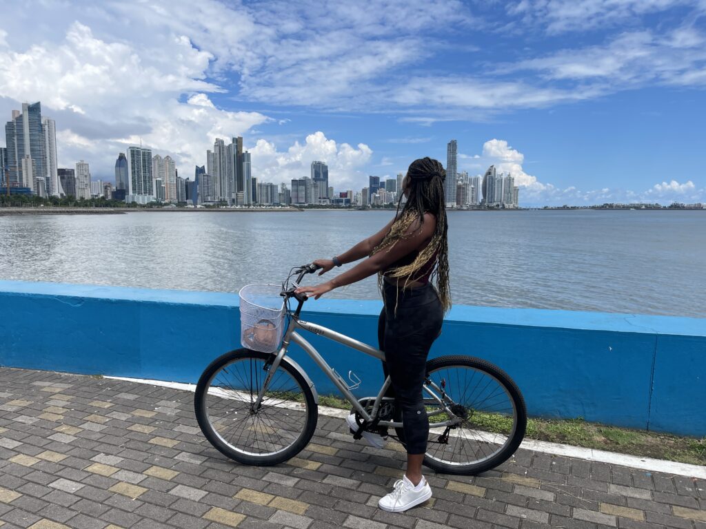 Panama city skyline, girl on bike